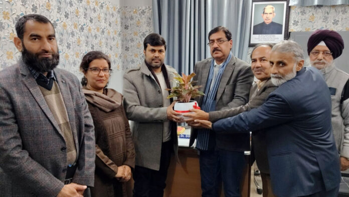 Management of Vridh Ashram handing over a sapling to JMC Commissioner, Dr. Devansh Yadav in Jammu on Saturday.