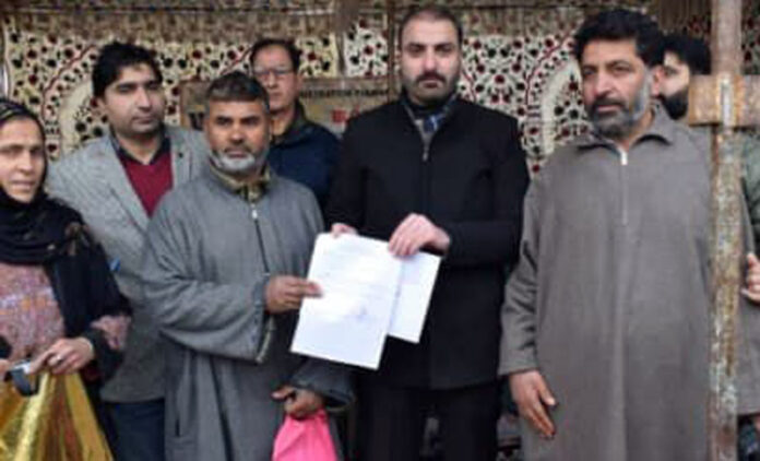 DC Pulwama handing over sanction letter to a beneficiary.