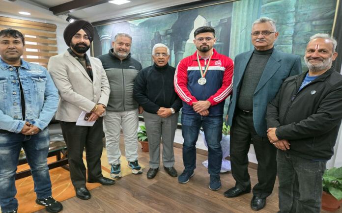 Weightlifter posing with Vice-Chancellor, University of Jammu and along with officials.