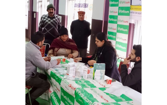 Team of Doctors examining patients during free medical camp at Deoli on Friday.