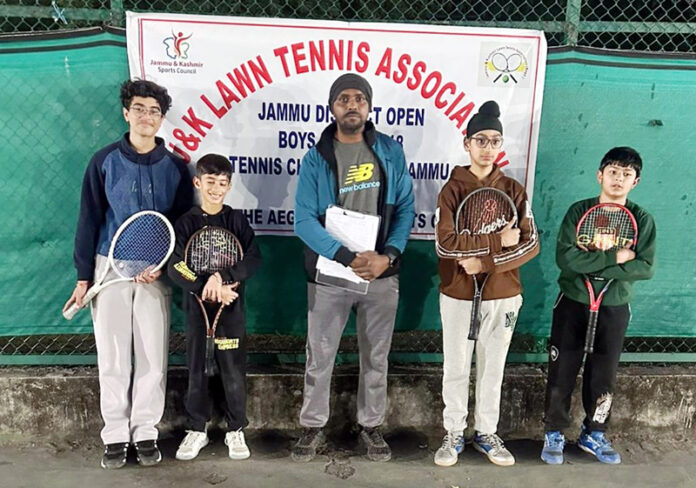 Tennis players posing with official.