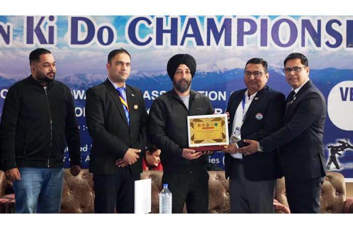 Dignitaries receiving memento from organisers during an event.