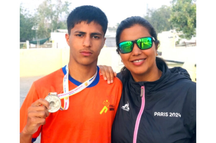Silver medallist Muneer Hussain with his coach Bilquis Mir.
