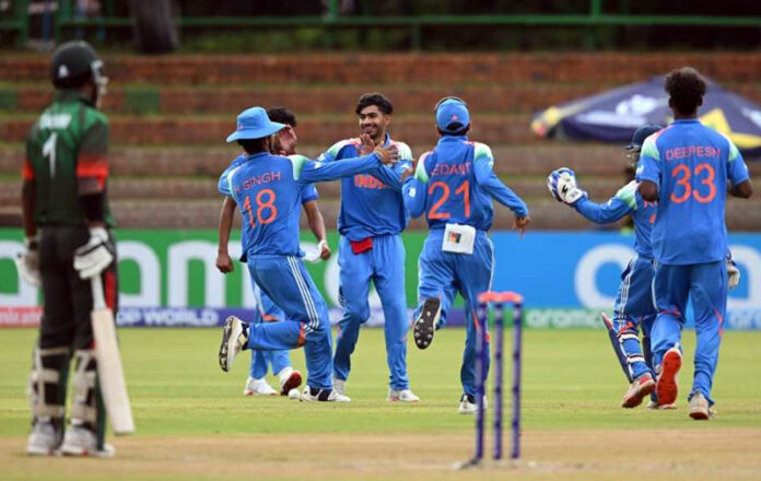 Vihaan Malhotra celebrating with team members after taking wicket in match against Bangladesh.