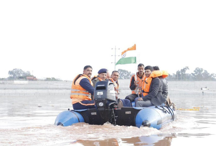 Officers in a boat after inaugurating Tawi Boating Festival.