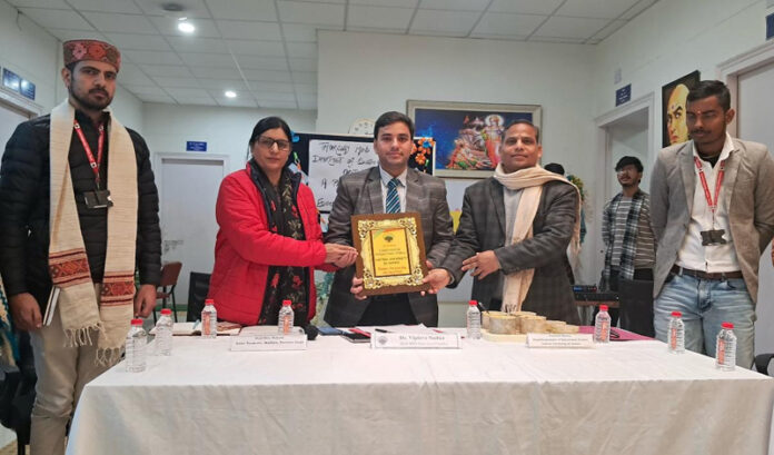Chief guest being presented memento during panel discussion at CUJ.