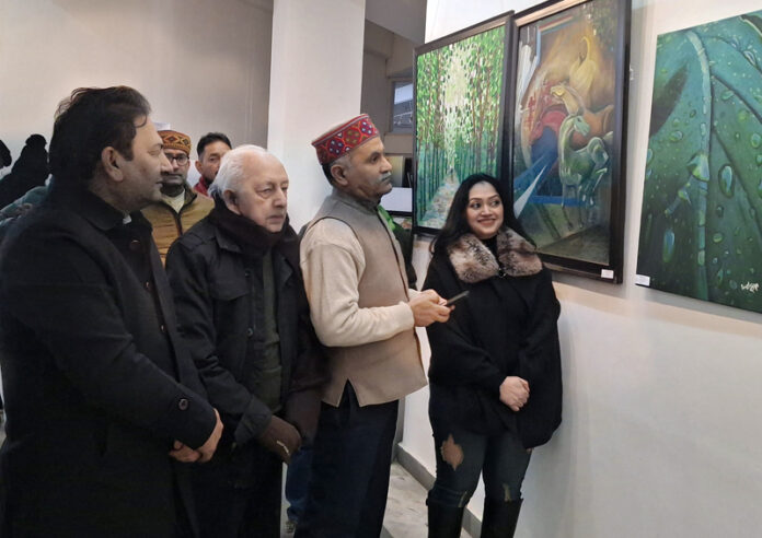 Shakti Pathak watching an artwork displayed at Kala Kendra Jammu on Thursday.