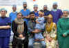 A team of doctors posing with a child and his parents after performing a landmark cochlear implant surgery on him at SMVD Narayana Hospital, Katra.