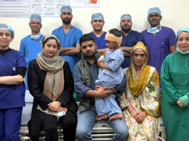 A team of doctors posing with a child and his parents after performing a landmark cochlear implant surgery on him at SMVD Narayana Hospital, Katra.