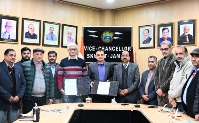 Officers display copies of MoU signed between SKUAST-Jammu and IIT Jammu.