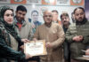 BJP general secretary (Org), Ashok Koul handing over a certificate to a participant in recently held Swadeshi Mela at Srinagar on Thursday.