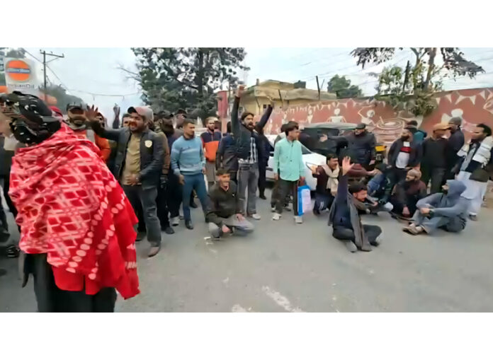 People raise slogans during a protest in Reasi as public transport was hit due to transporters protest. People raise slogans during a protest in Reasi as public transport was hit due to transporters protest.