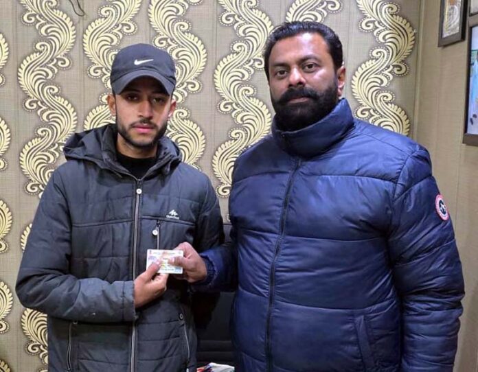 A beneficiary getting Ayushman Bharat Card during a programme organised by Samvedna Society in Jammu on Thursday.