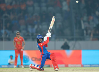 DC player hitting shot during match against Gujarat Giants.