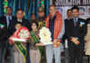 LG Ladakh Kavinder Gupta presenting trophy to students during a programme.