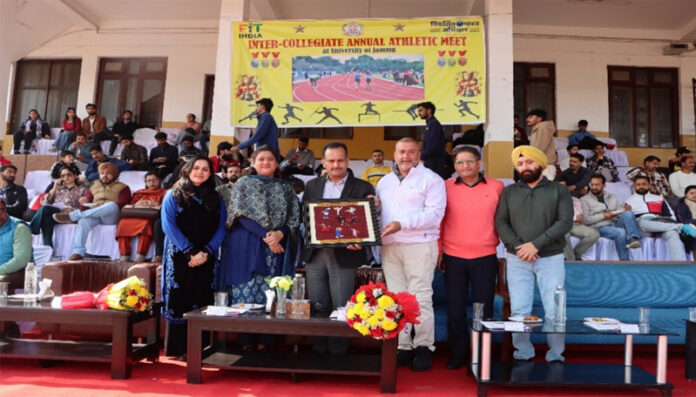 Dignitary receiving memento from organisers during a programme at Jammu University.