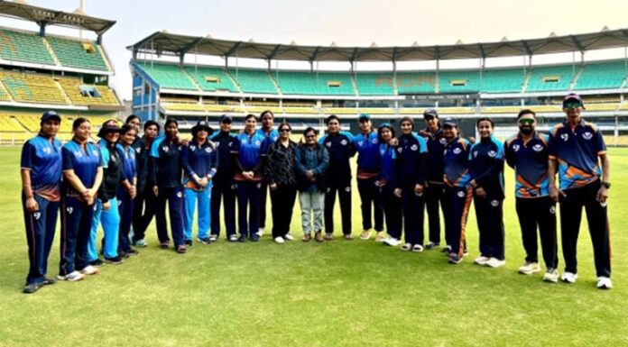 Women cricket team posing for group photograph.