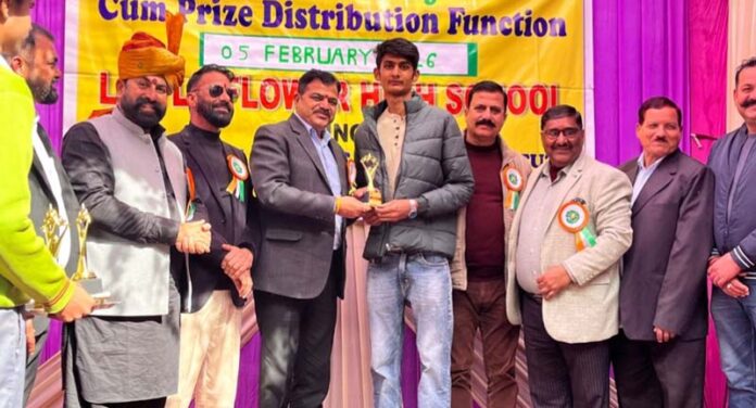 Dignitaries presenting trophy to a student.