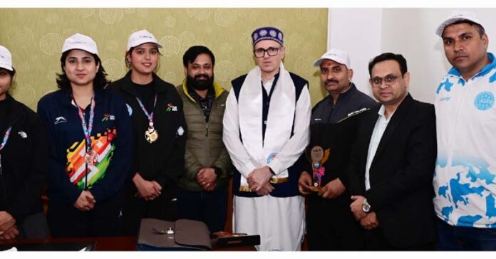 Medal winners posing along with CM Omar Abdullah.