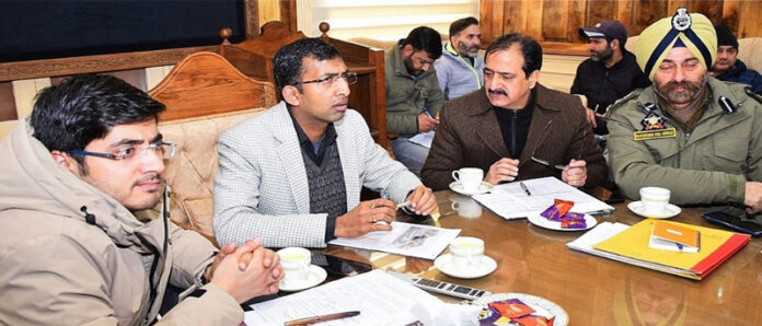 Div Com Kashmir chairing a meeting on Saturday.