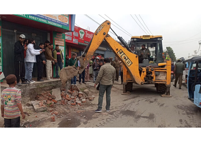 JMC men and machinery removing encroachment in Jammu on Wednesday.