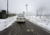 Fresh snowfall in Qazigund on Sunday. - Excelsior/Sajad Dar