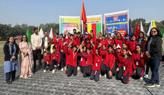 Dignitaries posing along with students during a programme.