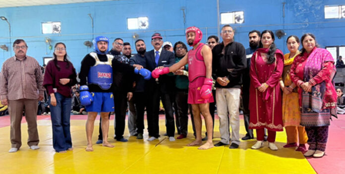 Dignitaries posing along Wushu athletes.