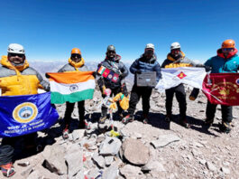 Mountaineers from NIM and JIM&WS posing with flags atop Mt. Aconcagua after successfully completing their historic ascent.