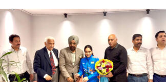 Dignitaries honouring Asia Cup Gold Medalist Aneesha Sharma during a programme.