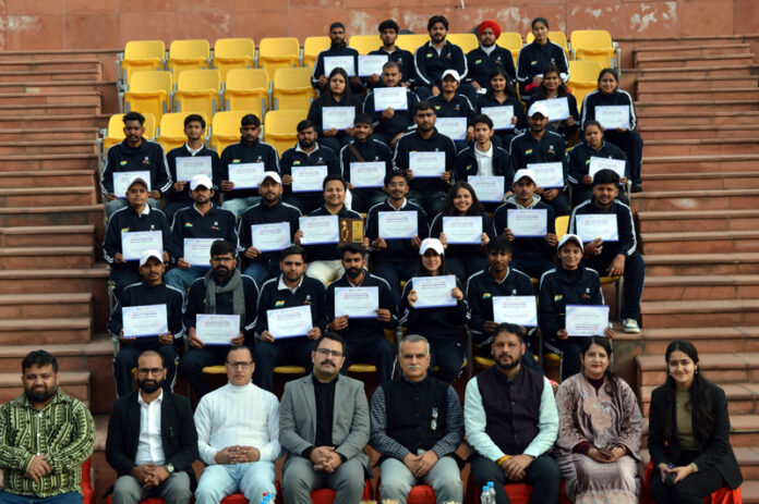 Participants posing with their certificates alongside dignitaries during valedictory ceremony of Inter-State Youth Exchange Programme in Jammu.
