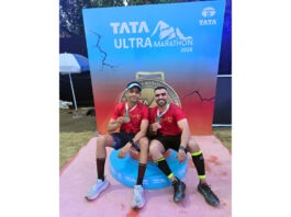 Iron Tribe athletes posing along with medals.