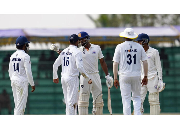 Paras Dogra and Mayank Agarwal exchanging words following an on-field incident involving substitute fielder KV Aneesh at KSCA Stadium in Hubli.