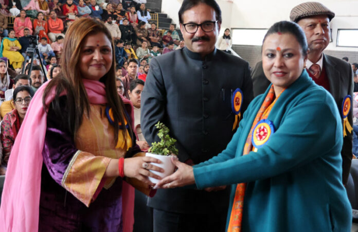 Dignitary receiving plant from school management.