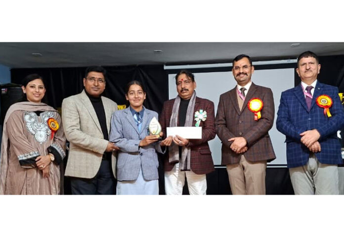 Dignitaries presenting award to a student.