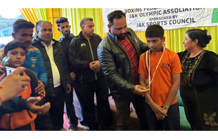 Dignitary presenting medal to a winner during prize distribution ceremony. Dignitary presenting medal to a winner during prize distribution ceremony.
