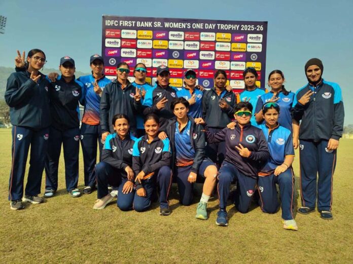 Women cricket team posing for group photograph.