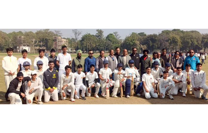 Cricket players posing along with technical staff during trials.