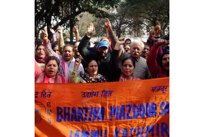 Workers of Hindustan Pencils Pvt Ltd along with BMS activists raise slogans during a protest in Jammu on Monday.