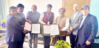 Senior officers of J&K Bank and representatives of M/s AGI Infra Limited displaying copies of Bank's sanction for housing project.