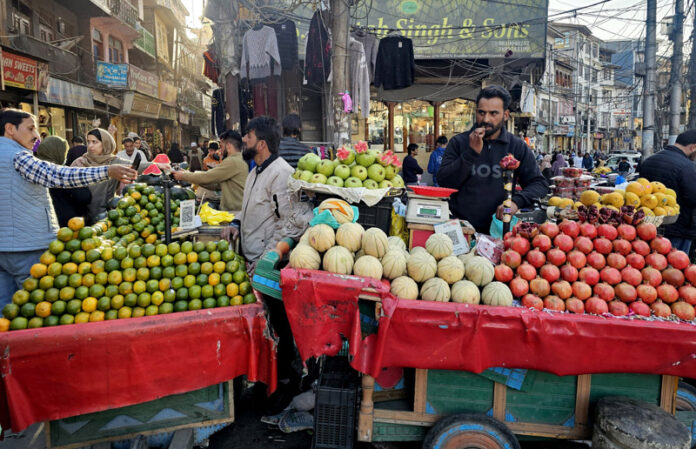 Roadside vendors selling different varieties of fruits in Srinagar on Saturday. -Excelsior/Shakeel