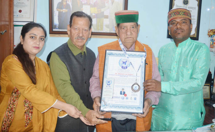 Dr M L Dogra being presented with “UN Book of World Records-2026”.