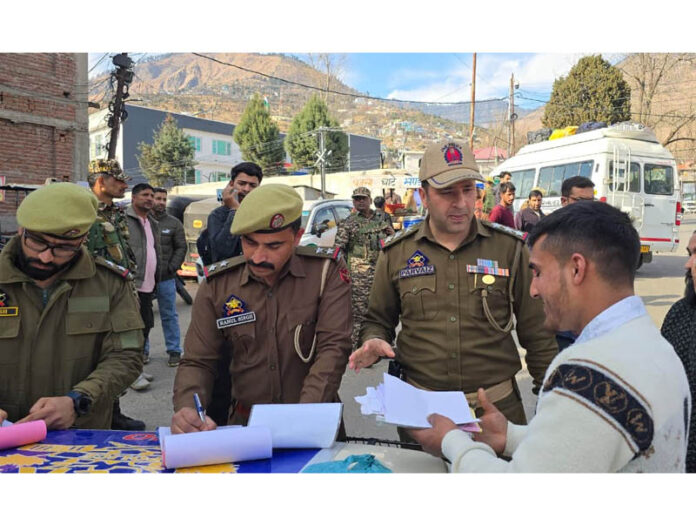 Police officials checking route permits and other documents of e-rickshaw/auto operators in Doda town. Police officials checking route permits and other documents of e-rickshaw/auto operators in Doda town.