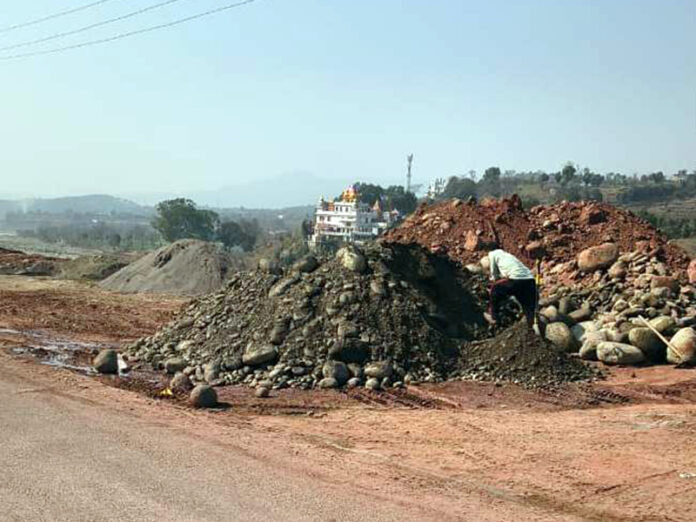 Sand and other minor minerals dumped on a roadside in Saranoo area of Rajouri.