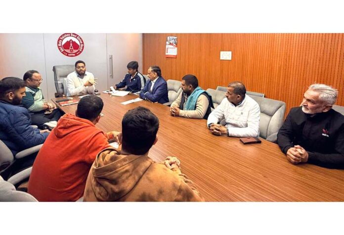 CEO chairing meeting of Shrine Board with delegation from various sectors.