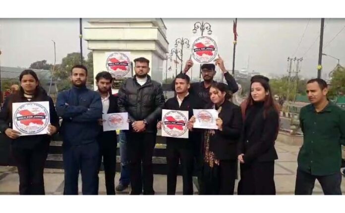 Students protesting near statue of Maharaja Hari Singh at Jammu on Sunday.