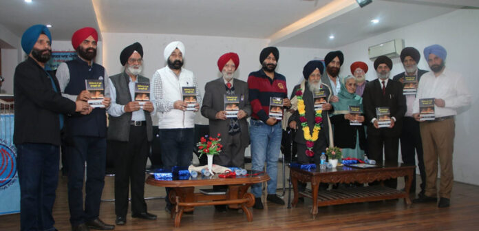 Intellectuals and prominent personalities during a book release function at Jammu.