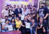 Medal winners posing along with dignitaries.