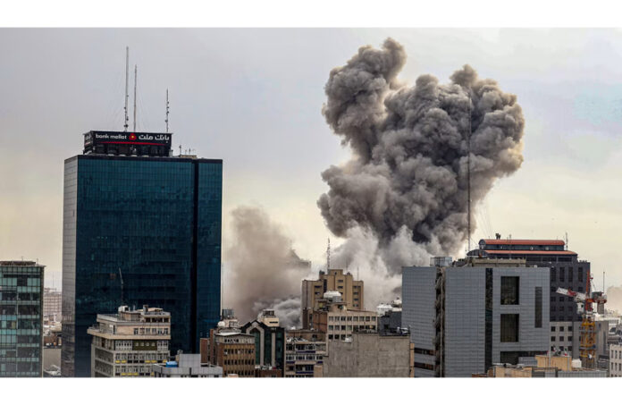 Smoke from an explosion rises into the sky above the Iranian capital, Tehran on Monday.