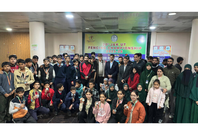 Fencers along with dignitaries posing with medals during closing ceremony.